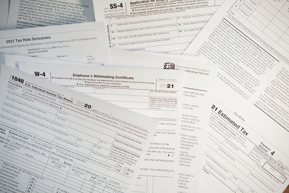 1040 and W-4 tax papers scattered
